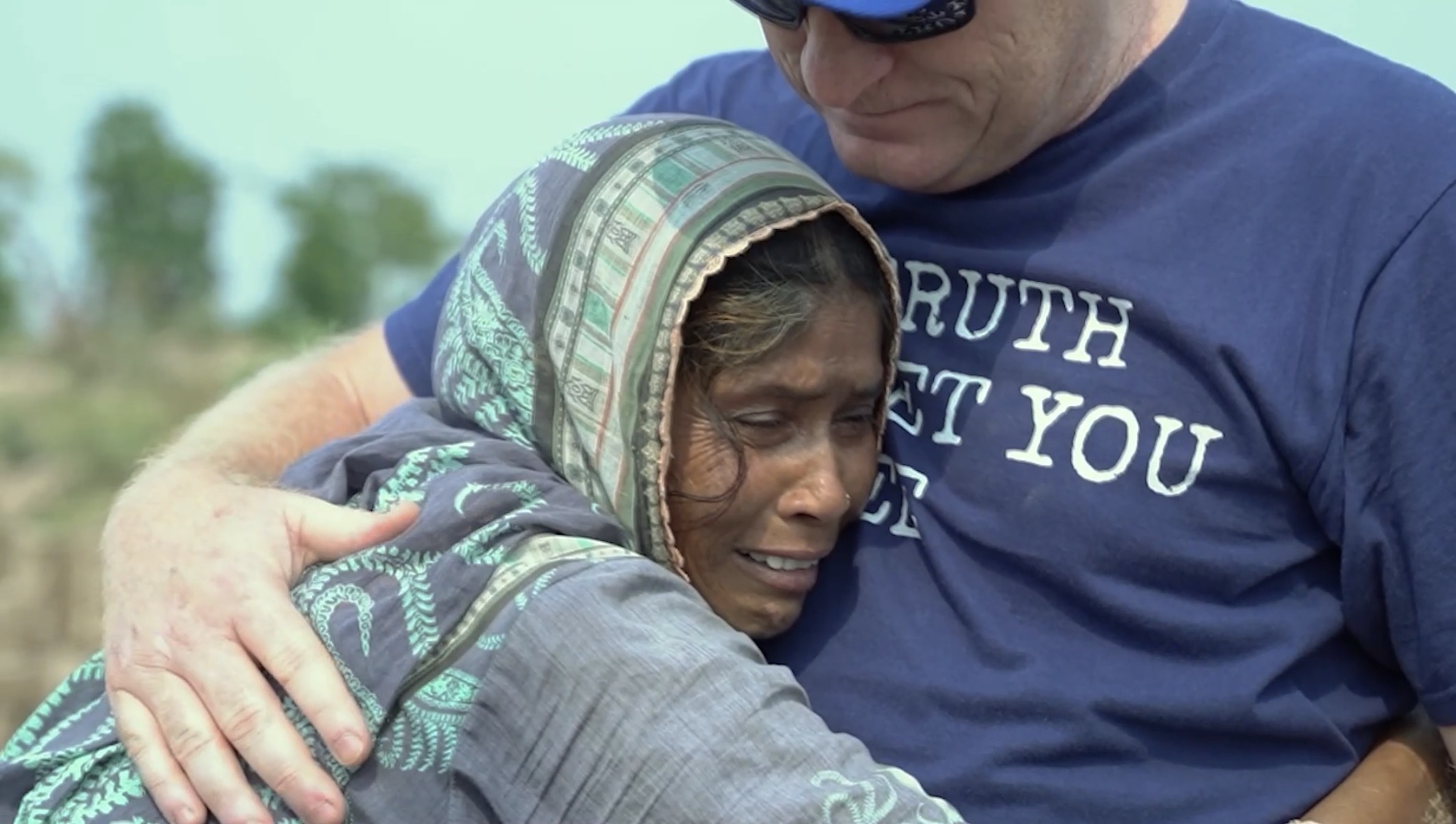 Aaron Hutchings embraces a woman after her family is freed from bonded labor in Pakistan